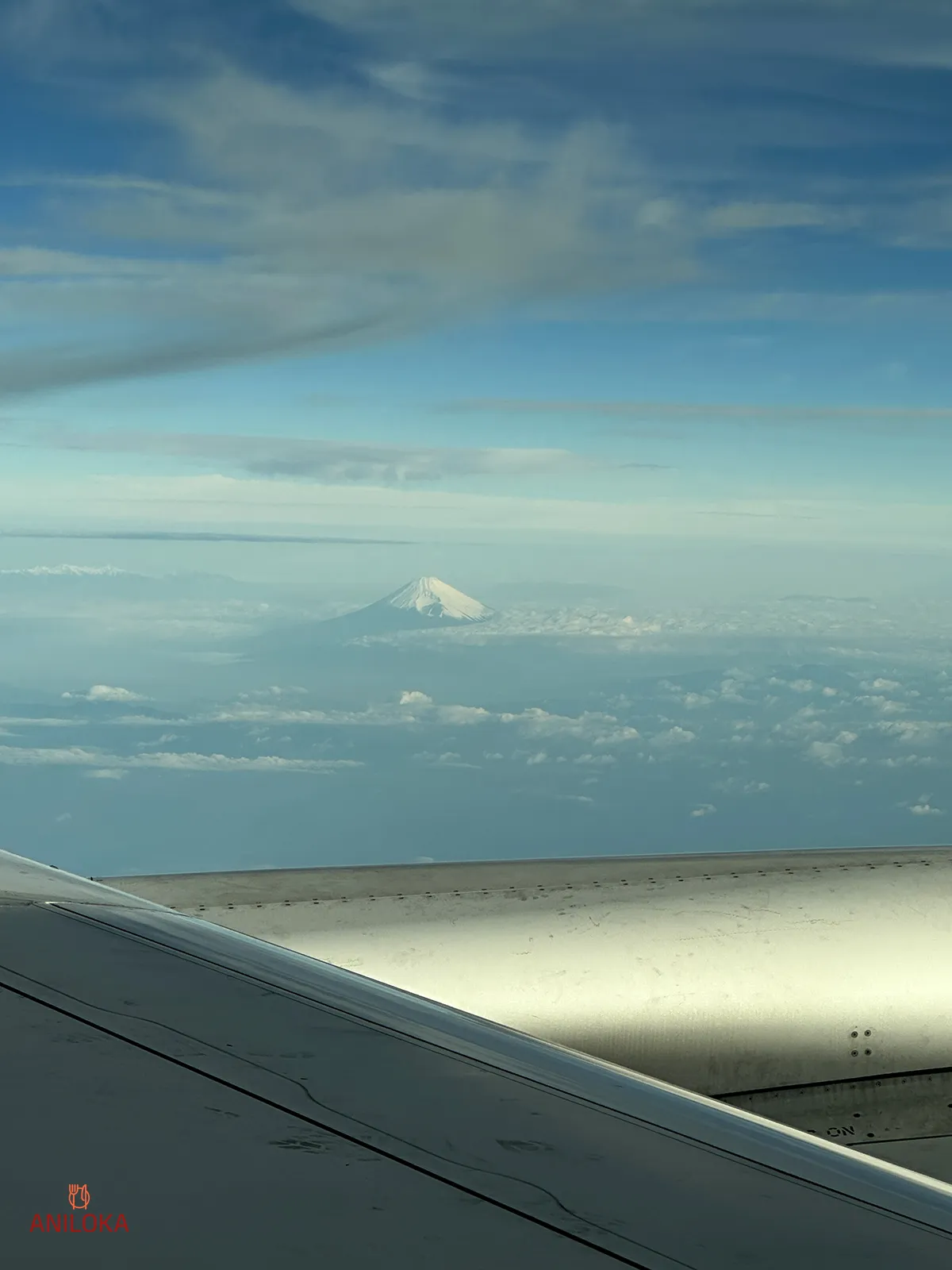 Mount Fuji View on Singapore Airlines Window Slightly Blocked by the wing and engine Mount Fuji View on Singapore Airlines Window Slightly Blocked by the wing and engine